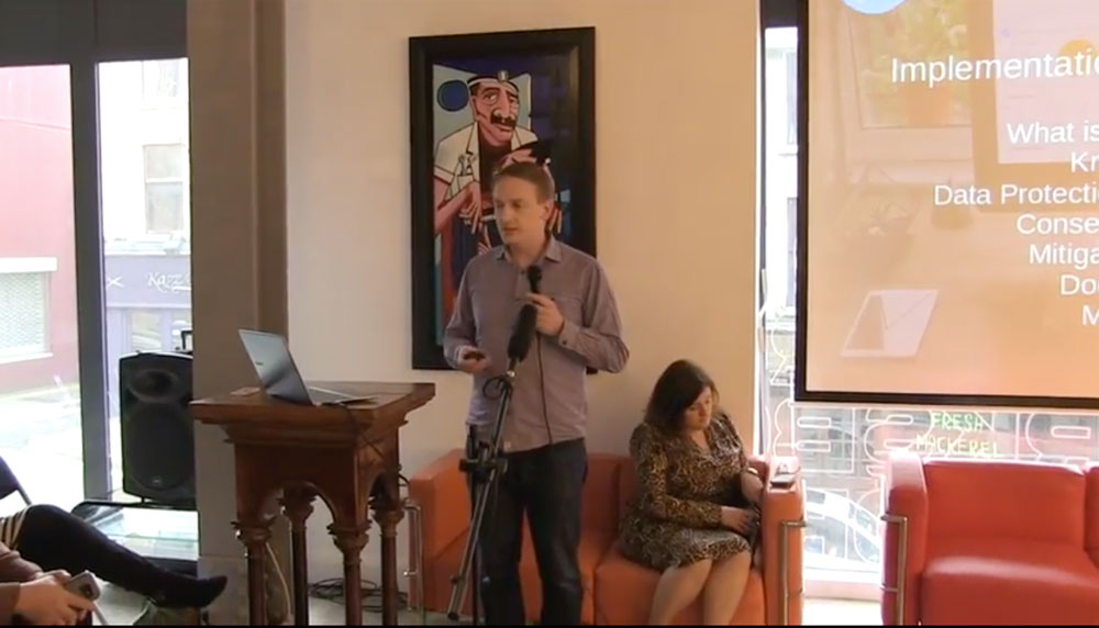 Speaker presenting a data protection talk to a seated audience at a STEAMworks event